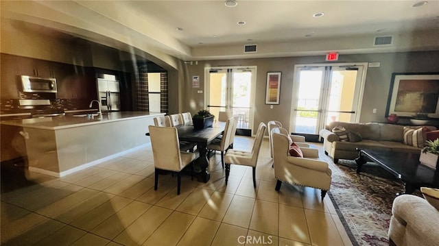 5961 Silveira St, Eastvale, CA 92880 - dining space with arched walkways, recessed lighting, and light tile patterned floors