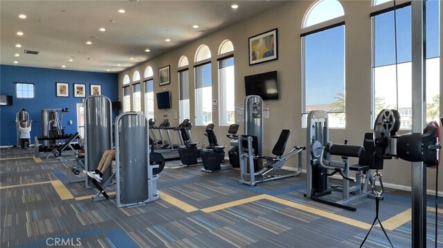 5961 Silveira St, Eastvale, CA 92880 - exercise room featuring dark carpet, recessed lighting, and baseboards