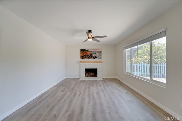 10319 Hemphill Ct, San Diego, CA 92126 - unfurnished living room with a brick fireplace, light wood-type flooring, ceiling fan, and baseboards