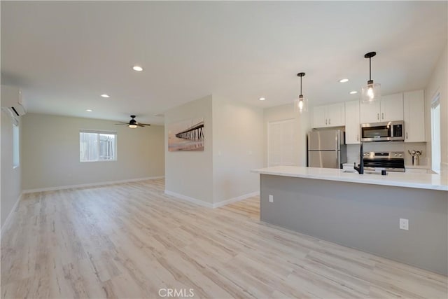 10319 Hemphill Ct, San Diego, CA 92126 - kitchen with stainless steel appliances, light countertops, recessed lighting, hanging light fixtures, and white cabinetry