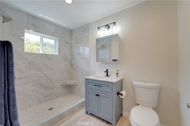10319 Hemphill Ct, San Diego, CA 92126 - bathroom with tiled shower, toilet, vanity, and baseboards