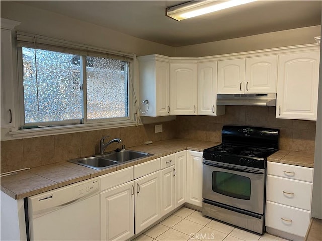 kitchen with stainless steel gas range oven, white dishwasher, under cabinet range hood, a sink, and white cabinets