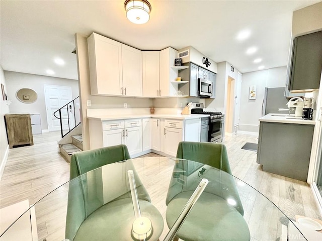 738 N Fairhaven St, Anaheim, CA 92801 - kitchen featuring stainless steel appliances, baseboards, light countertops, light wood-style flooring, and recessed lighting