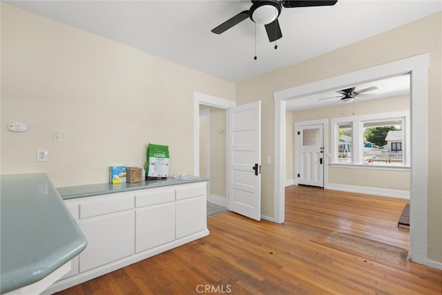 1810 Park St, Paso Robles, CA 93446 - kitchen featuring a ceiling fan, white cabinetry, light wood finished floors, and baseboards