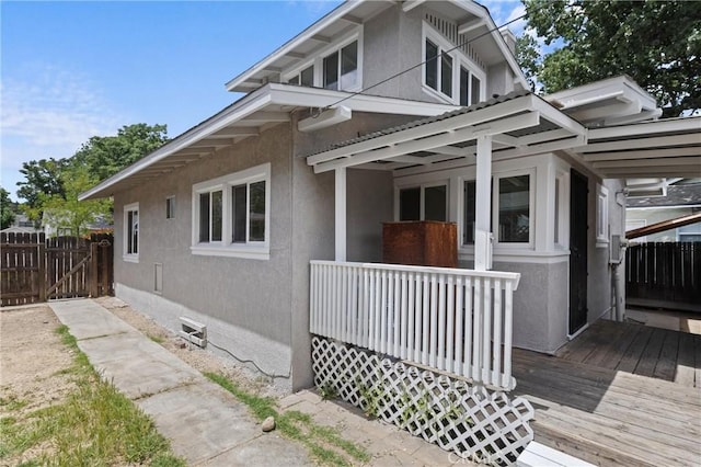 1810 Park St, Paso Robles, CA 93446 - view of property exterior featuring stucco siding, a deck, and a gate