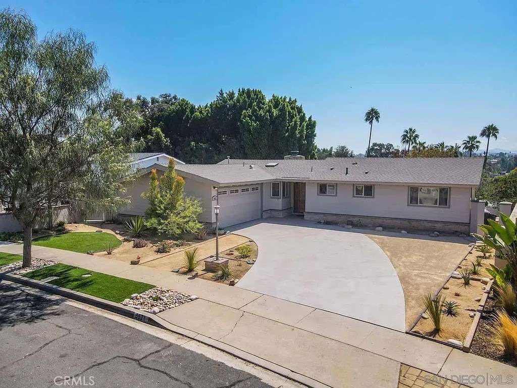 single story home featuring an attached garage and concrete driveway