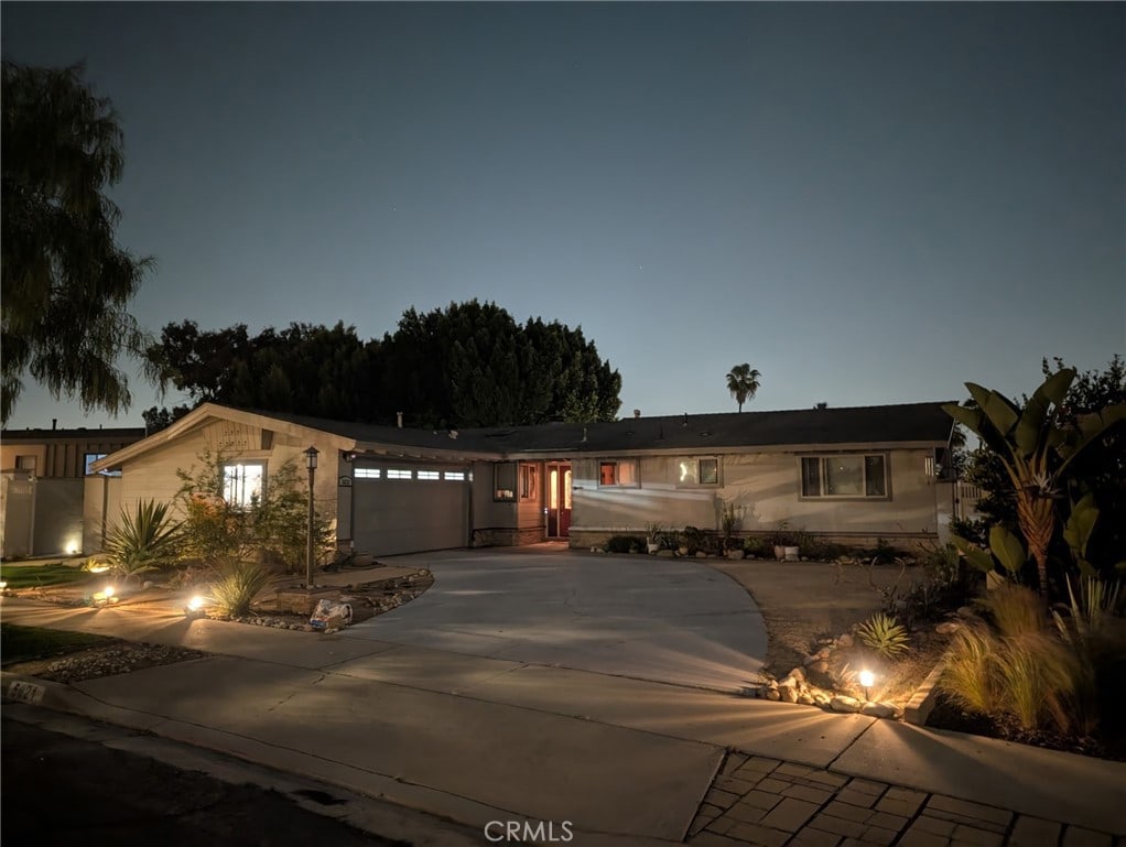 view of front of home featuring concrete driveway and a garage