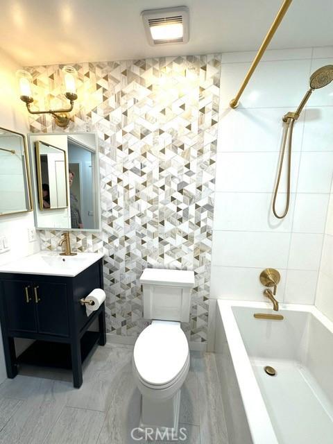 1428 Brett Pl Unit 86, San Pedro, CA 90732 - bathroom with vanity, washtub / shower combination, toilet, and tile walls