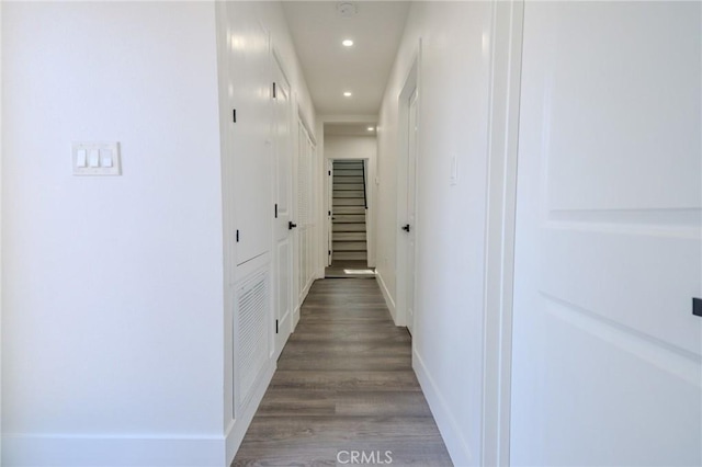 hall with recessed lighting, wood finished floors, and baseboards