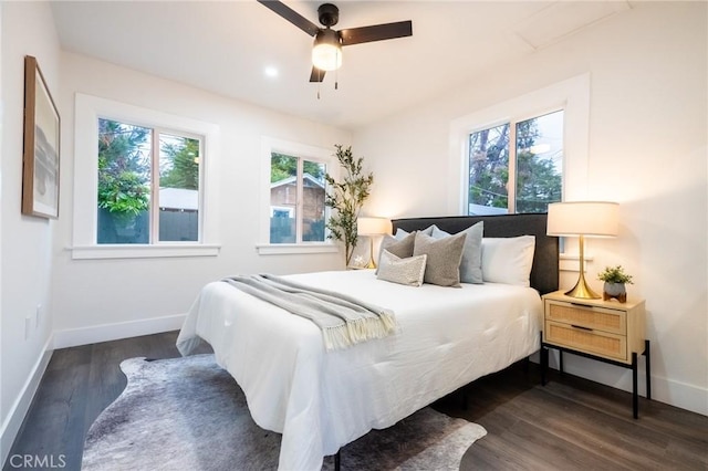 bedroom with dark wood-type flooring, baseboards, and ceiling fan