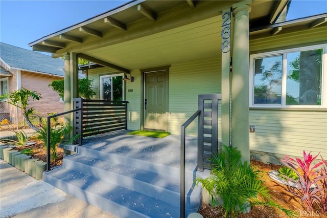view of exterior entry with covered porch