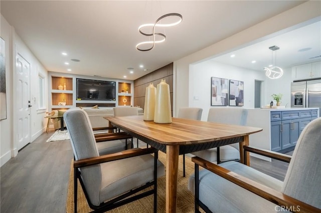 dining area featuring wood finished floors, recessed lighting, a chandelier, and baseboards