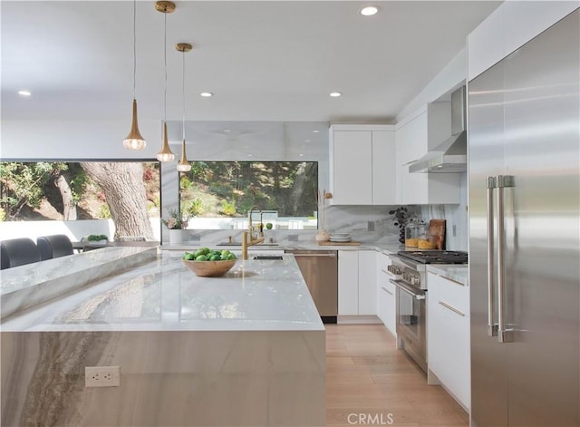 3920 Weslin Ave, Sherman Oaks, CA 91423 - kitchen with high end appliances, wall chimney range hood, modern cabinets, a sink, and recessed lighting