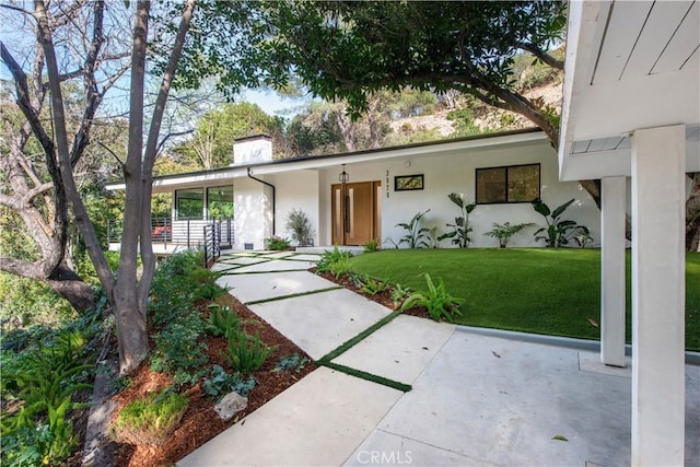 3920 Weslin Ave, Sherman Oaks, CA 91423 - view of front facade featuring a front lawn, a chimney, and stucco siding