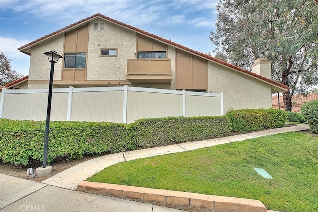 1207 Porto Grande Unit 1, Diamond Bar, CA 91765 - view of home's exterior featuring a chimney, stucco siding, and a tile roof