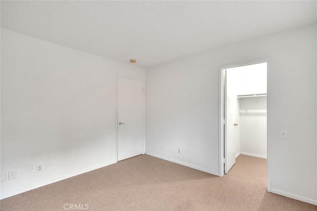 1207 Porto Grande Unit 1, Diamond Bar, CA 91765 - unfurnished bedroom featuring light carpet, a spacious closet, a closet, and baseboards