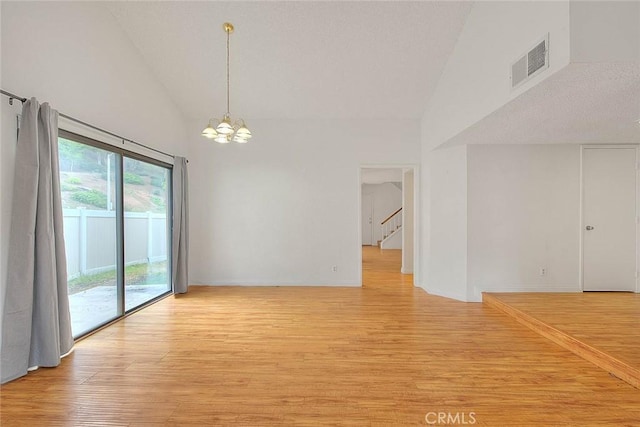 1207 Porto Grande Unit 1, Diamond Bar, CA 91765 - empty room featuring high vaulted ceiling, a chandelier, light wood-style flooring, and stairway