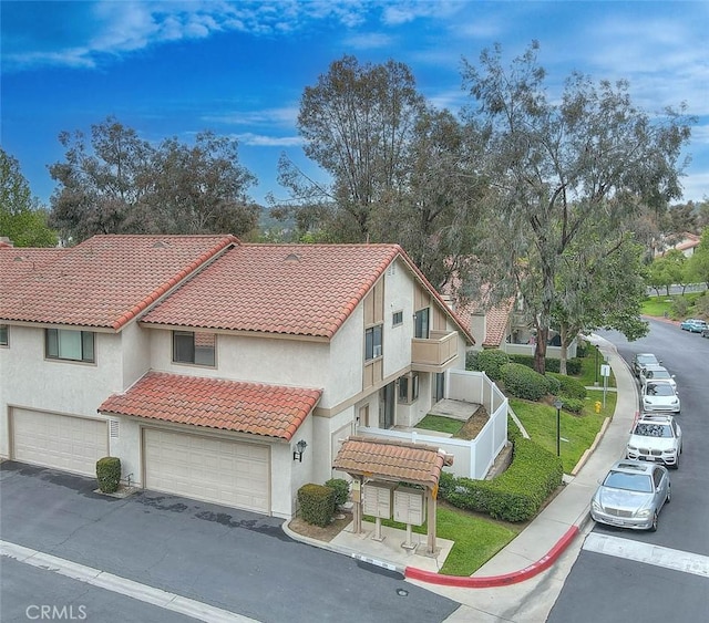 1207 Porto Grande Unit 1, Diamond Bar, CA 91765 - view of front of home with a tiled roof, stucco siding, and a garage
