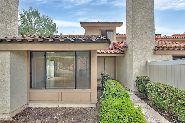 1207 Porto Grande Unit 1, Diamond Bar, CA 91765 - doorway to property featuring a tiled roof, stucco siding, and fence
