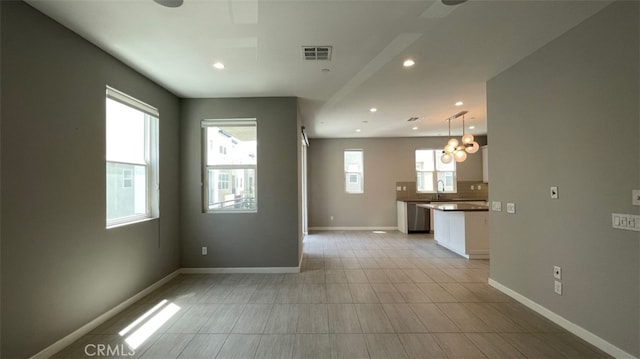 2296 Synergy, Irvine, CA 92614 - unfurnished room with plenty of natural light, a chandelier, baseboards, recessed lighting, and a sink