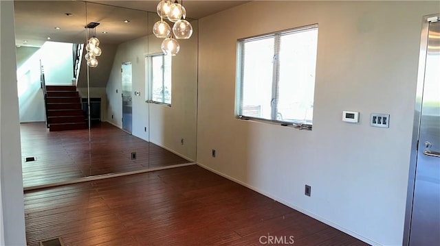 1419 Angelus Ave, Los Angeles, CA 90026 - unfurnished dining area featuring wood finished floors, stairs, and baseboards