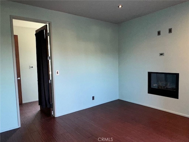 1419 Angelus Ave, Los Angeles, CA 90026 - spare room with wood finished floors, baseboards, recessed lighting, and a glass covered fireplace
