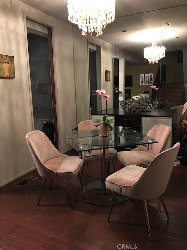 1419 Angelus Ave, Los Angeles, CA 90026 - dining room featuring a chandelier, wood finished floors, and baseboards