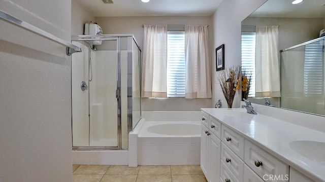 bathroom featuring a stall shower, a bath, tile patterned flooring, and double vanity