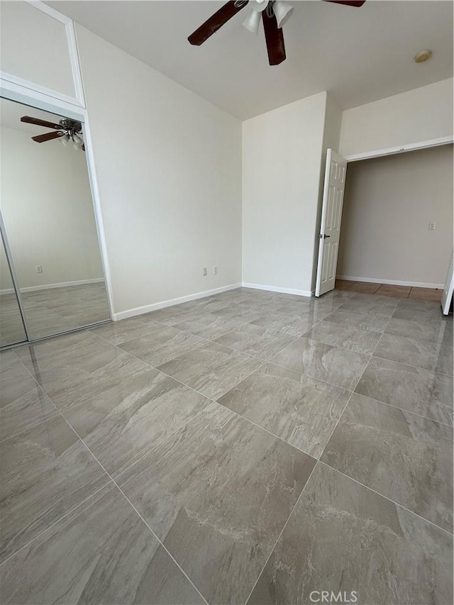 unfurnished bedroom featuring a ceiling fan and baseboards