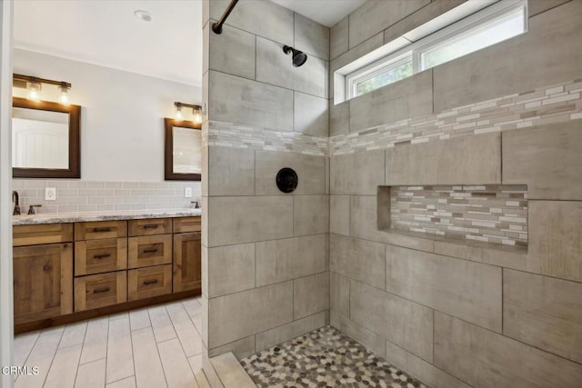 8730 Junipero Ave, Atascadero, CA 93422 - bathroom featuring tiled shower, double vanity, and decorative backsplash