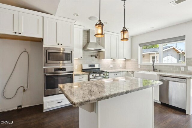 8730 Junipero Ave, Atascadero, CA 93422 - kitchen featuring appliances with stainless steel finishes, wall chimney range hood, a sink, white cabinets, and decorative backsplash