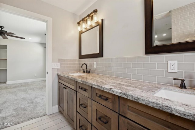 8730 Junipero Ave, Atascadero, CA 93422 - full bath with decorative backsplash, double vanity, a ceiling fan, and baseboards