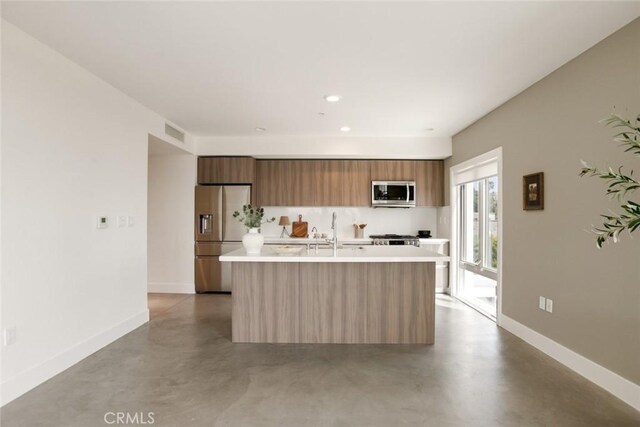 482 S Arroyo Pkwy Unit 408, Pasadena, CA 91105 - kitchen with stainless steel appliances, modern cabinets, light countertops, baseboards, and finished concrete flooring