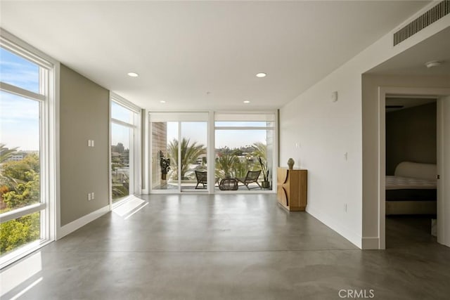 482 S Arroyo Pkwy Unit 408, Pasadena, CA 91105 - spare room featuring healthy amount of natural light, baseboards, finished concrete flooring, expansive windows, and recessed lighting