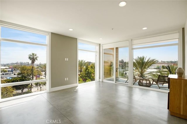 482 S Arroyo Pkwy Unit 408, Pasadena, CA 91105 - spare room with floor to ceiling windows, concrete flooring, healthy amount of natural light, baseboards, and recessed lighting