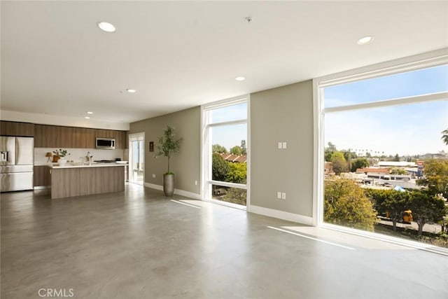 482 S Arroyo Pkwy Unit 408, Pasadena, CA 91105 - unfurnished living room with baseboards, concrete floors, and recessed lighting