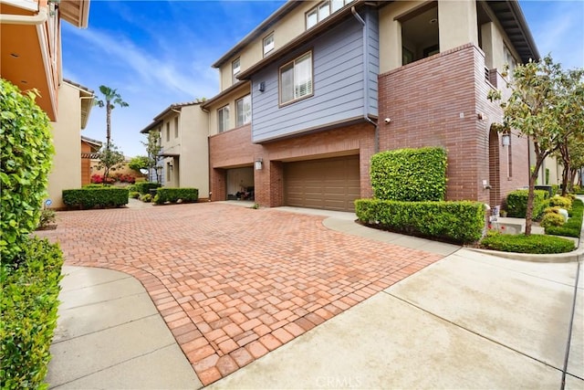 12474 Benton Dr Unit 2, Rancho Cucamonga, CA 91739 - view of front of property with brick siding, decorative driveway, and an attached garage
