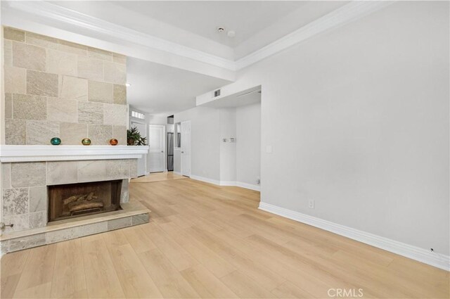 unfurnished living room featuring baseboards, light wood-style flooring, and a fireplace
