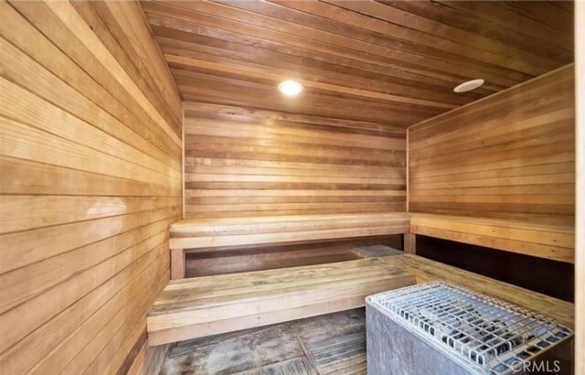 sauna with wooden ceiling and wood walls