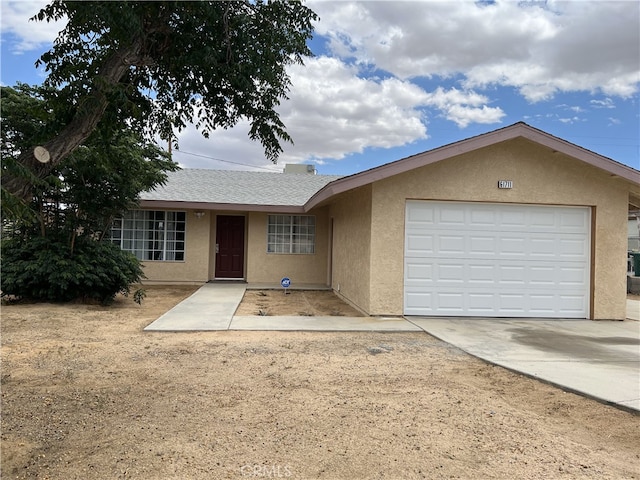 61711 Morningside Rd, Joshua Tree, CA 92252 - ranch-style house featuring stucco siding, concrete driveway, and a garage