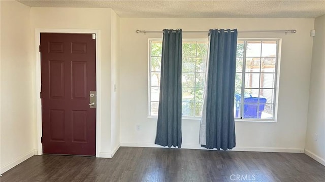 61711 Morningside Rd, Joshua Tree, CA 92252 - entrance foyer with dark wood-style flooring, baseboards, and a textured ceiling