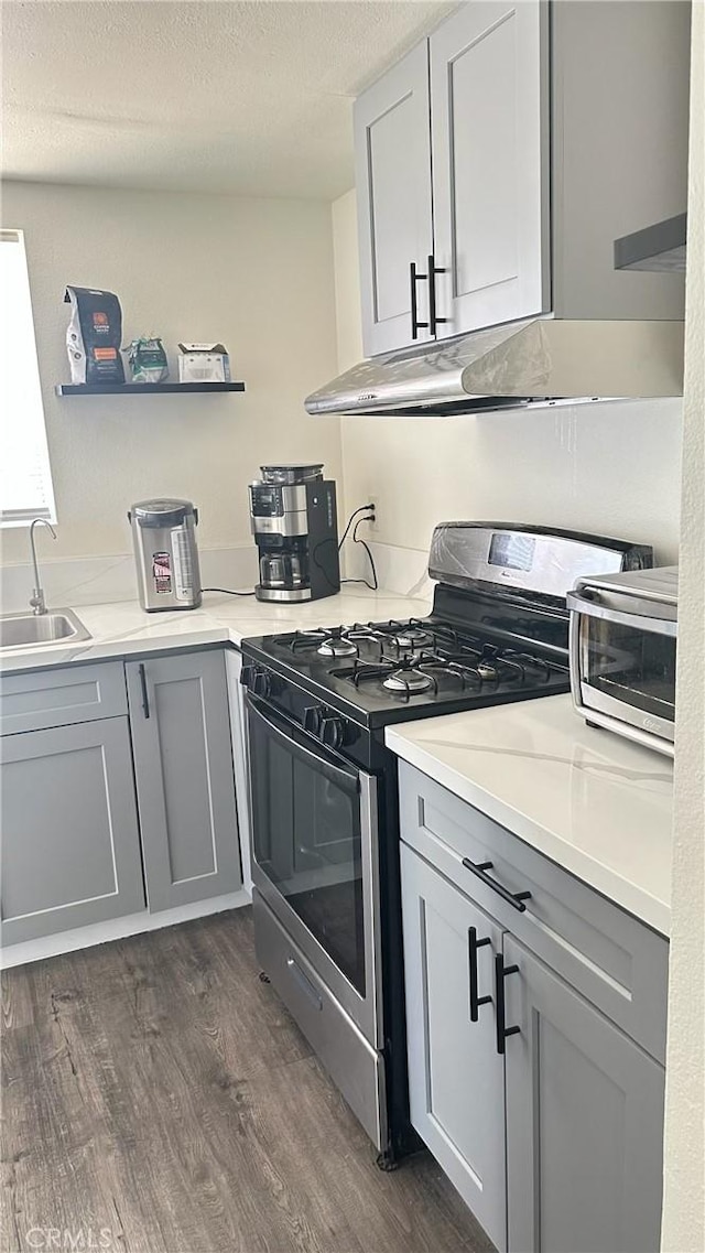 61711 Morningside Rd, Joshua Tree, CA 92252 - kitchen with stainless steel gas range oven, open shelves, a sink, dark wood finished floors, and gray cabinets