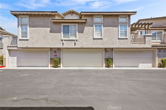 view of property with a garage and stucco siding