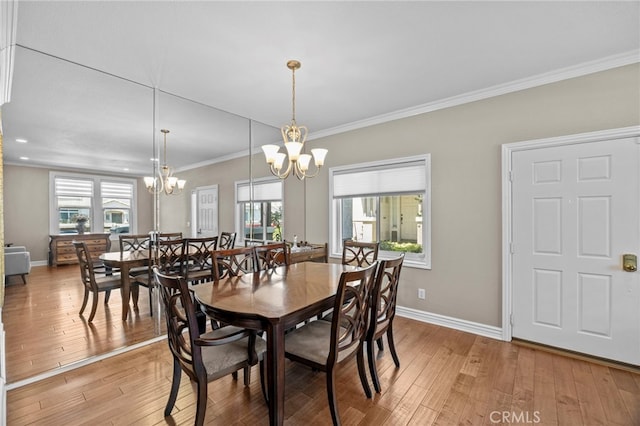 dining area with a chandelier, light wood-type flooring, baseboards, and ornamental molding