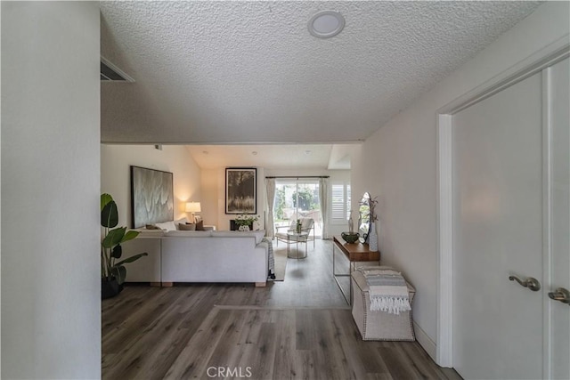 living area with wood finished floors and a textured ceiling