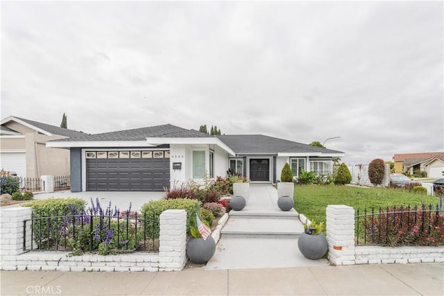 ranch-style house with an attached garage, driveway, and stucco siding