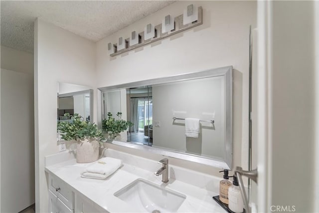 bathroom with a textured ceiling and vanity