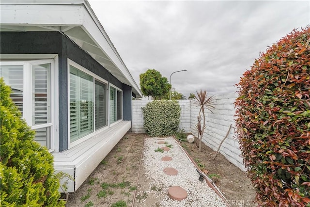 view of property exterior with fence