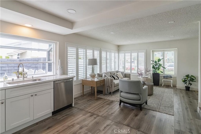living area with baseboards and light wood-style flooring