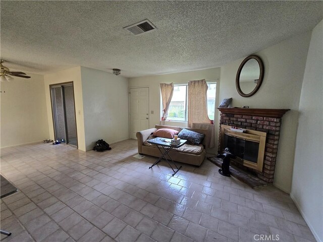 13436 Francisquito Ave Unit C, Baldwin Park, CA 91706 - living room with a fireplace, a textured ceiling, and ceiling fan